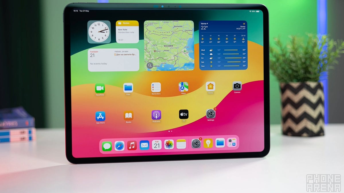 A black iPad Pro with a bright display showing the iPadOS home screen.