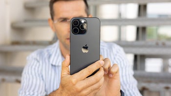 PhoneArena's Vic has a grip on the iPhone 16 Pro Max showing us the back panel with the camera bump.