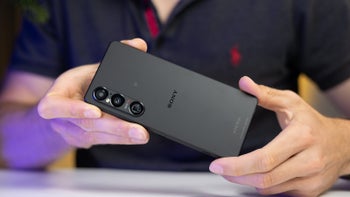 Two hands holding a black Sony Xperia 1 VI, showing its back.