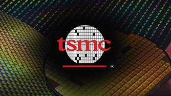 The TSMC silicon wafer logo is seen against a backdrop of silicon wafers.