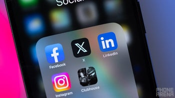 Home screen folder on iPhone shows social media platform icons such as Facebook, Instagram, and X.