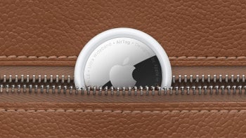 An AirTag is partially visible inside a brown leather zippered pouch.