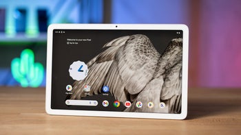 A white Google Pixel tablet on a wooden table.