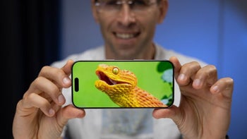 Holding up an iPhone 16 Pro to show off its display