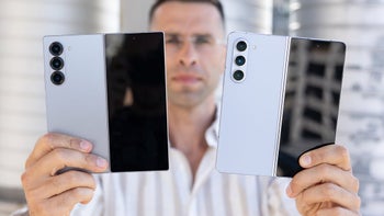 A person holding the Galaxy Z Fold 6 and Z Fold 5 next to each other, unfolded.