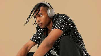 A person listening to music with a pair of Bose QuietComfort Ultra headphones.