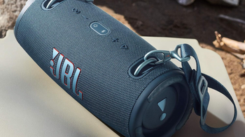 A close-up of the JBL Xtreme 3 portable Bluetooth speaker, featuring a durable fabric design and a sturdy carrying strap.