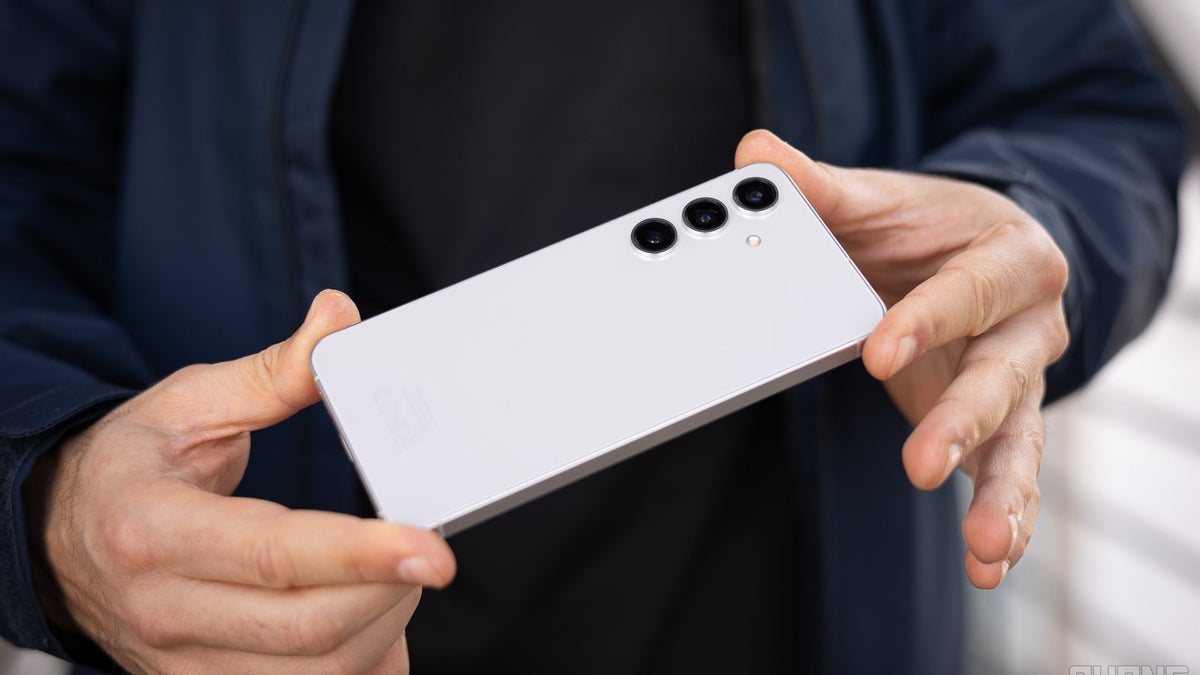 A person holding the Galaxy S24 with both hands