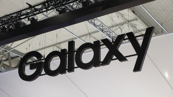 The Samsung Galaxy wordmark hangs from the ceiling at a trade show.