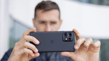 Man holding a Motorola Edge+ (2023) horizontally, showcasing its sleek design and advanced camera module.