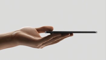 A hand holding a slim, black Oppo Find N3 smartphone.