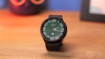 Galaxy Watch 6 Classic model on a wooden table.