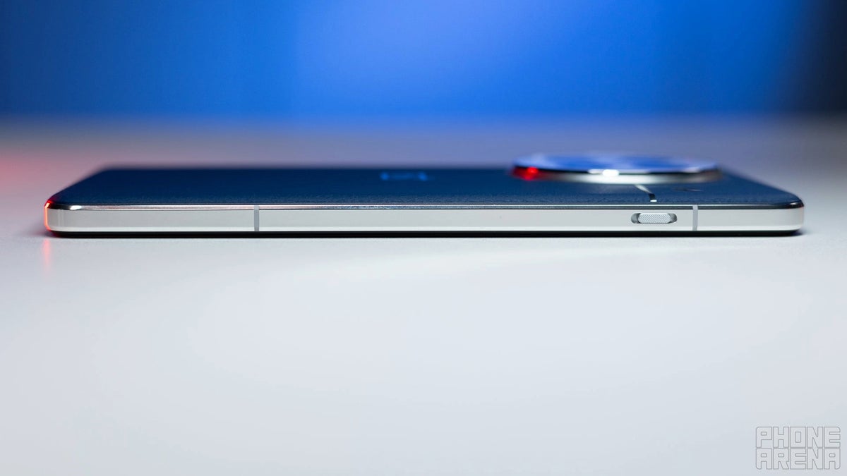 OnePlus 13 positioned face down on a white surface.