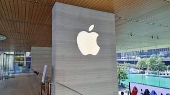 Image of the Apple logo displayed on a wall within an Apple Store.