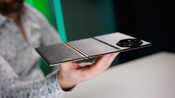 A man holding a foldable phone in hands.