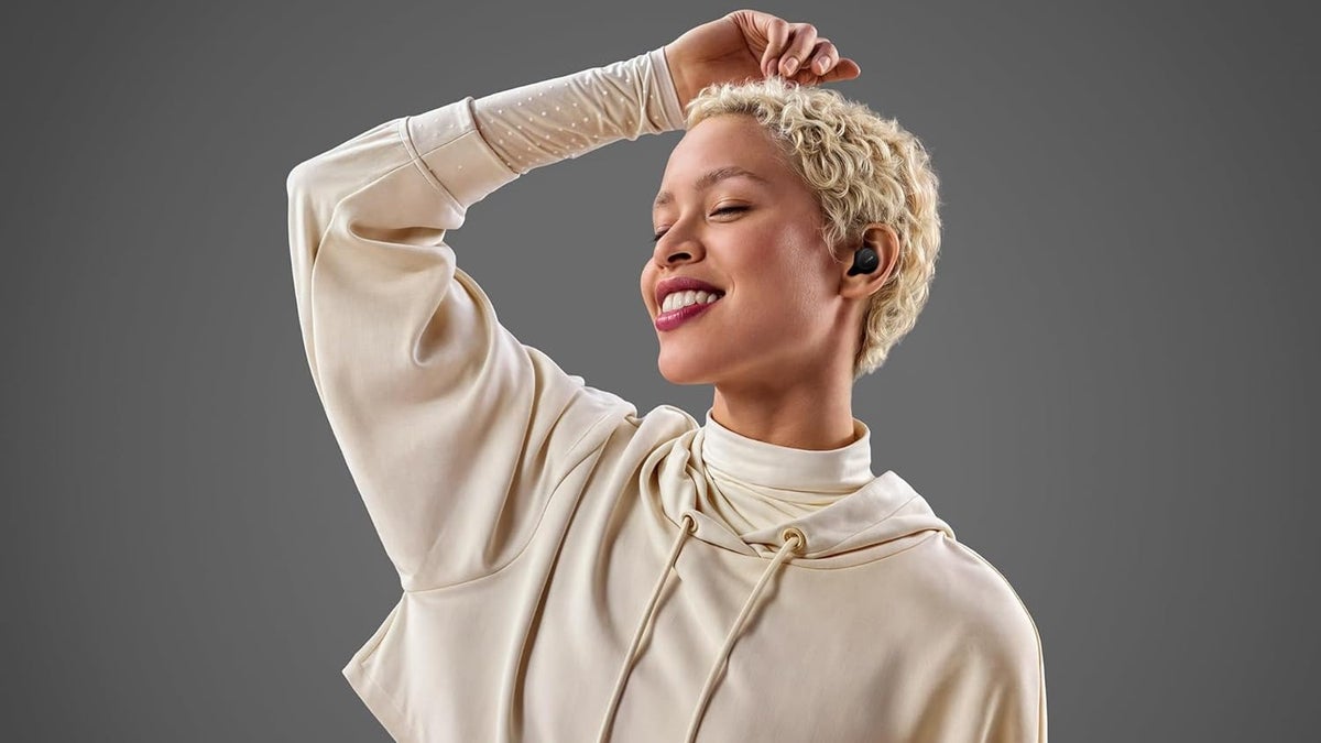 A woman wearing a pair of Jabra Elite 10 Gen 2.