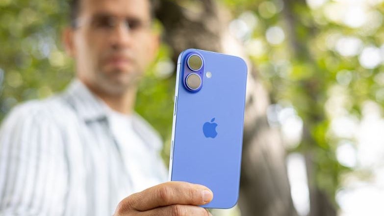 Holding the iPhone 16