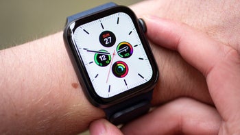 An Apple Watch Series 6 model worn on someone's left wrist has the digital crown pressed by the index finger on the right hand.