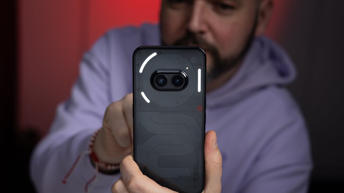 A photo of a person holding the Phone (2a) in their hands.