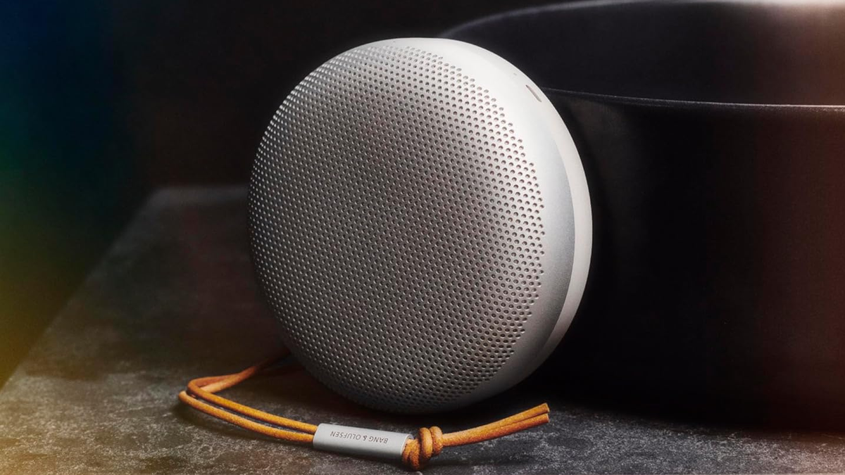 Bang and Olufsen Beosound A1 (Gen 2) speaker in a light color set against a dark background.