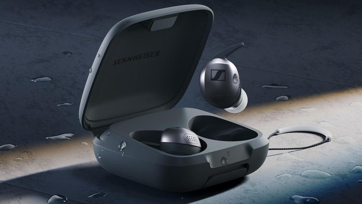 Sennheiser Momentum Sport earbuds in black with an open charging case, shown on a wet surface.