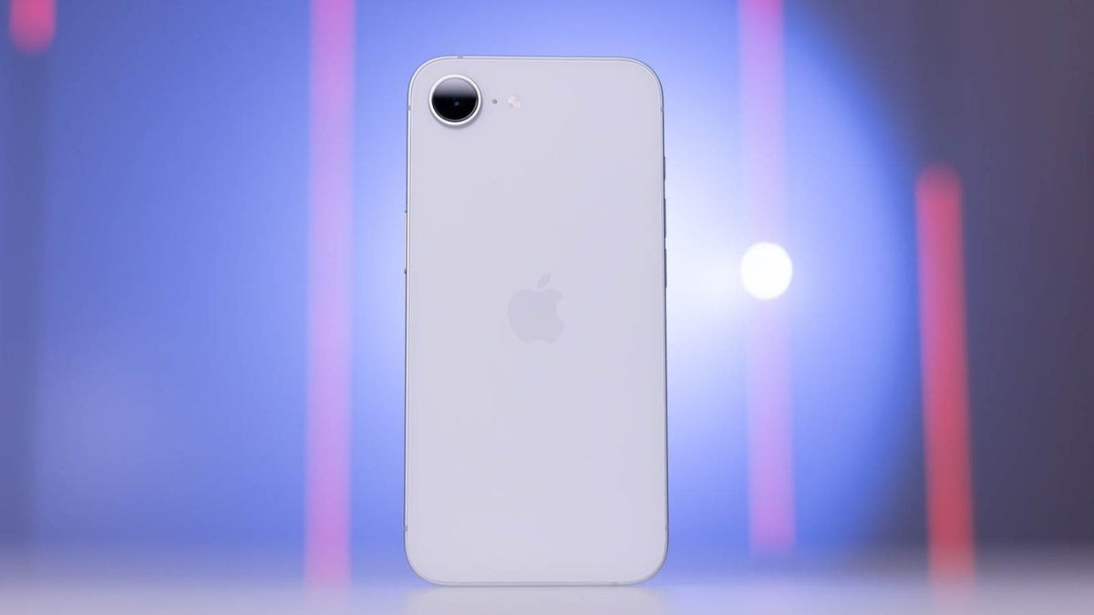 Phone stood up right on a table with back facing the camera.