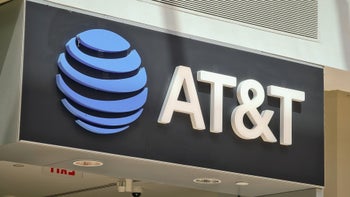 An AT&T logo sign with a blue globe and white letters on a dark background.