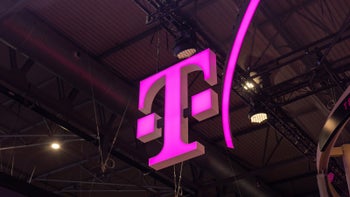 Image showing the T-Mobile logo, a magenta "T", suspended from a ceiling in an indoor setting.