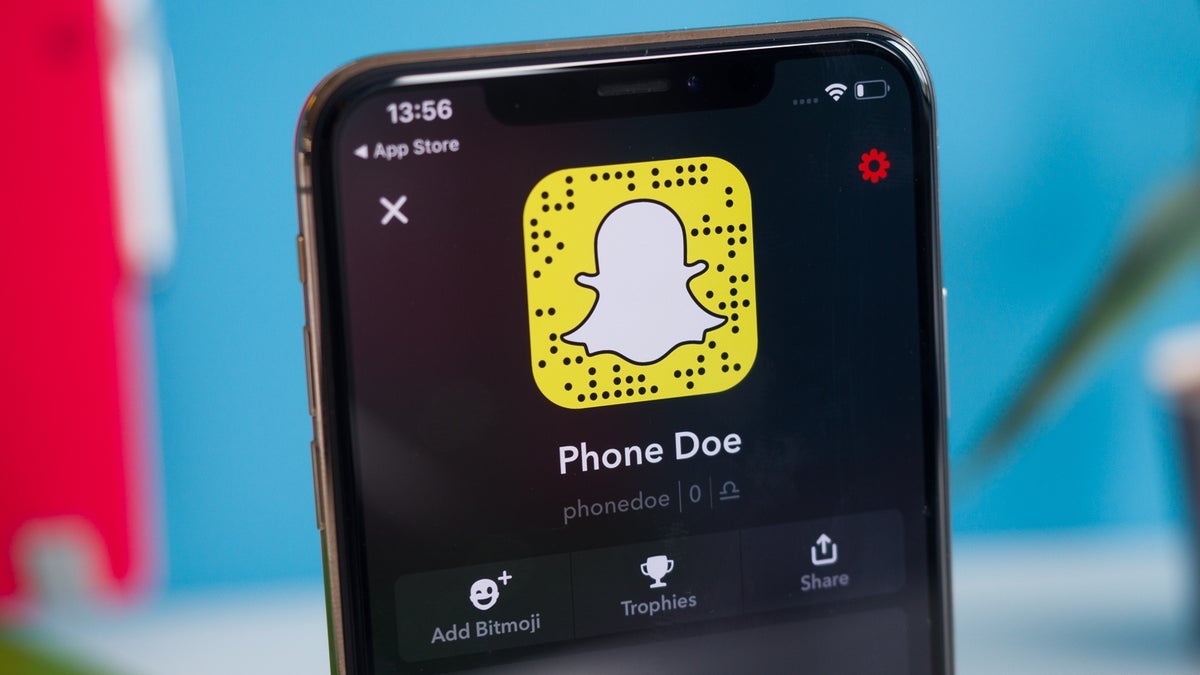 A close-up of a smartphone screen displaying the Snapchat app with a ghost logo.