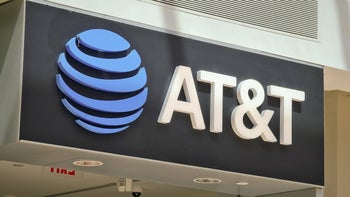 An AT&T logo sign with a blue globe and white letters on a dark background.