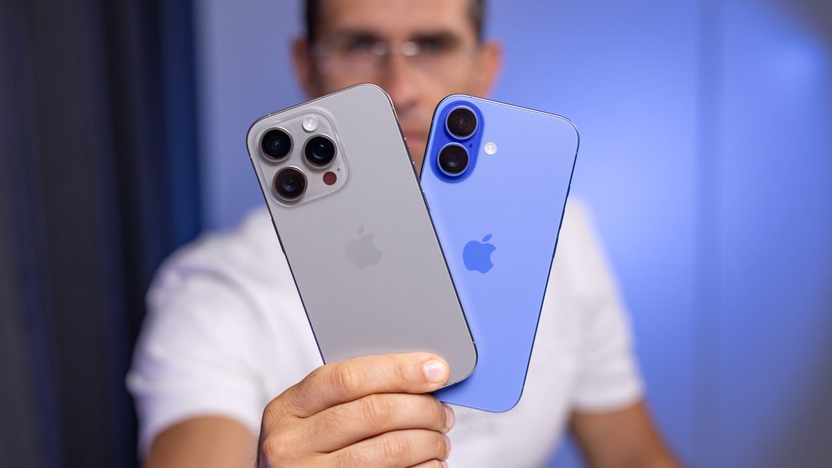 A man holding a couple of iPhones.