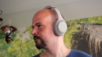 A person wears the Sony WH-1000XM4 headphones, showcasing their design.