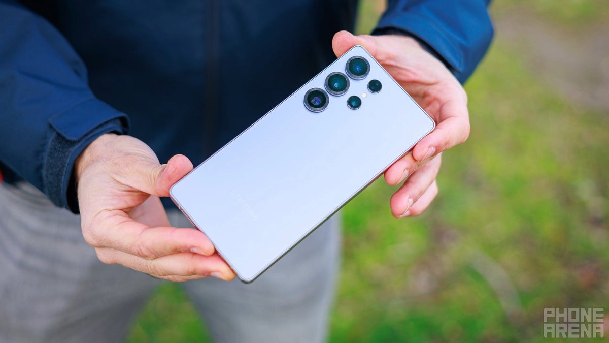 A photo of a person holding the Galaxy S25 Ultra in their hands.