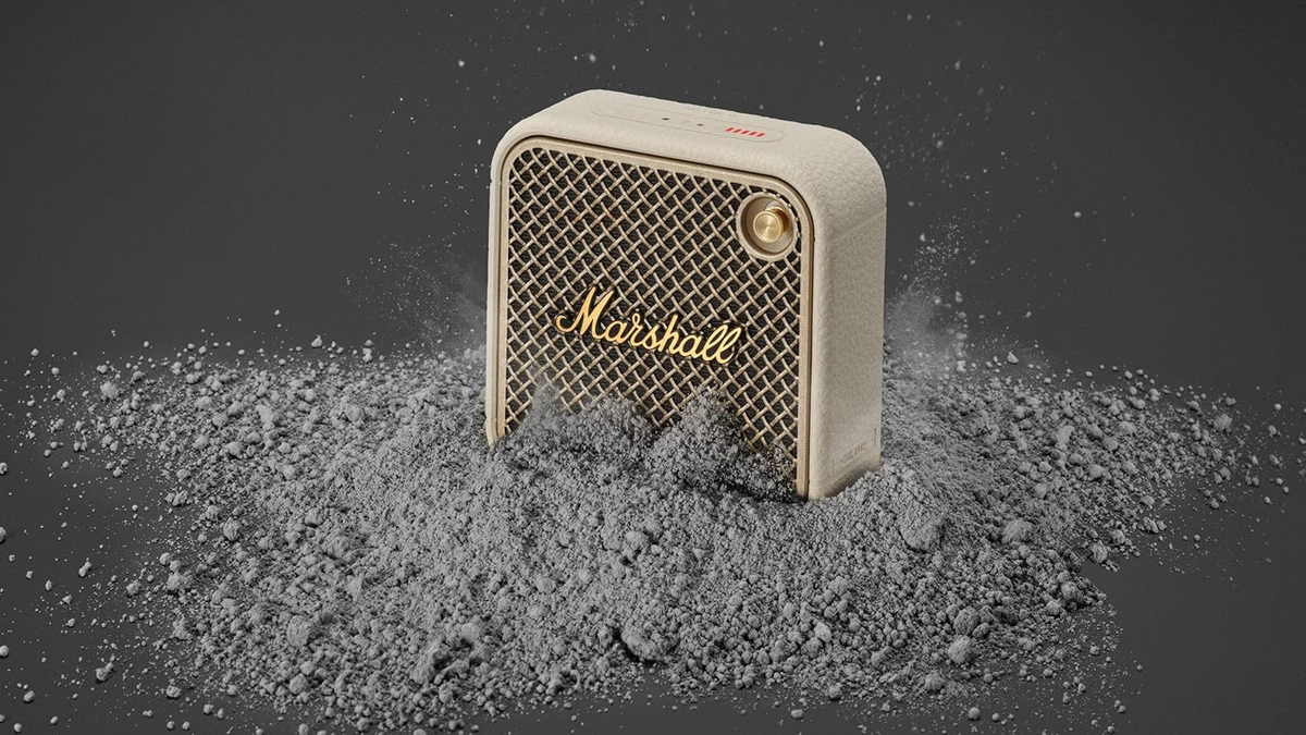 Marshall Willen II speaker in Cream color with gray powder in front of it, emphasizing its dust resistance.