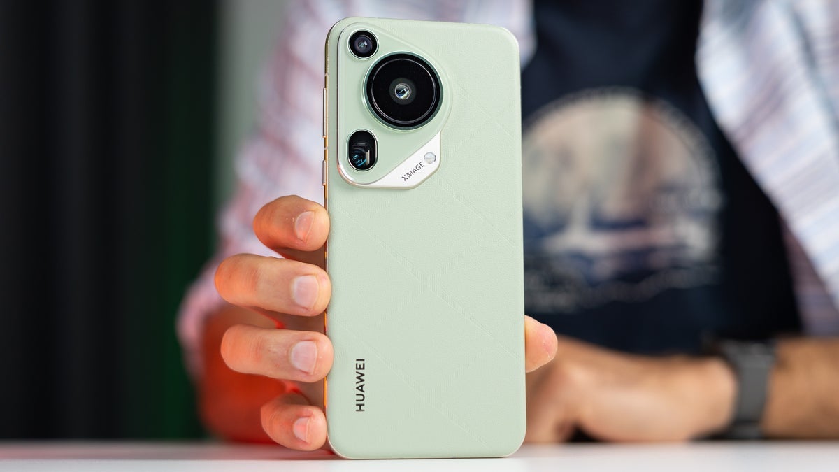The Huawei Pura 70 Ultra is propped up on a table with its rear panel facing us.