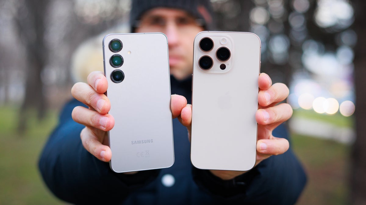 A Samsung and an Apple phone held in hand.