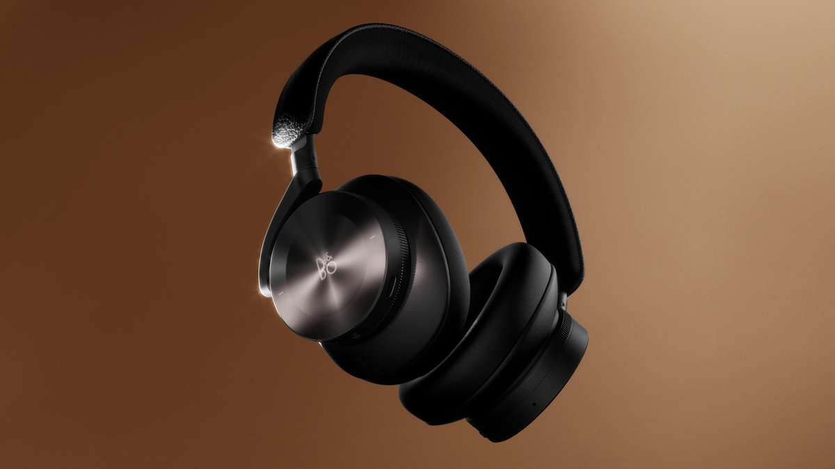 A pair of black B&O Beoplay H95 shown against a brown gradient background.