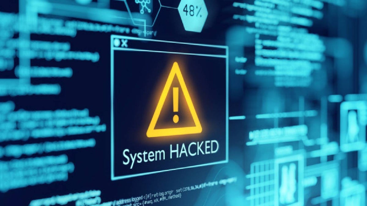 A computer screen shows a warning that the system has been hacked.