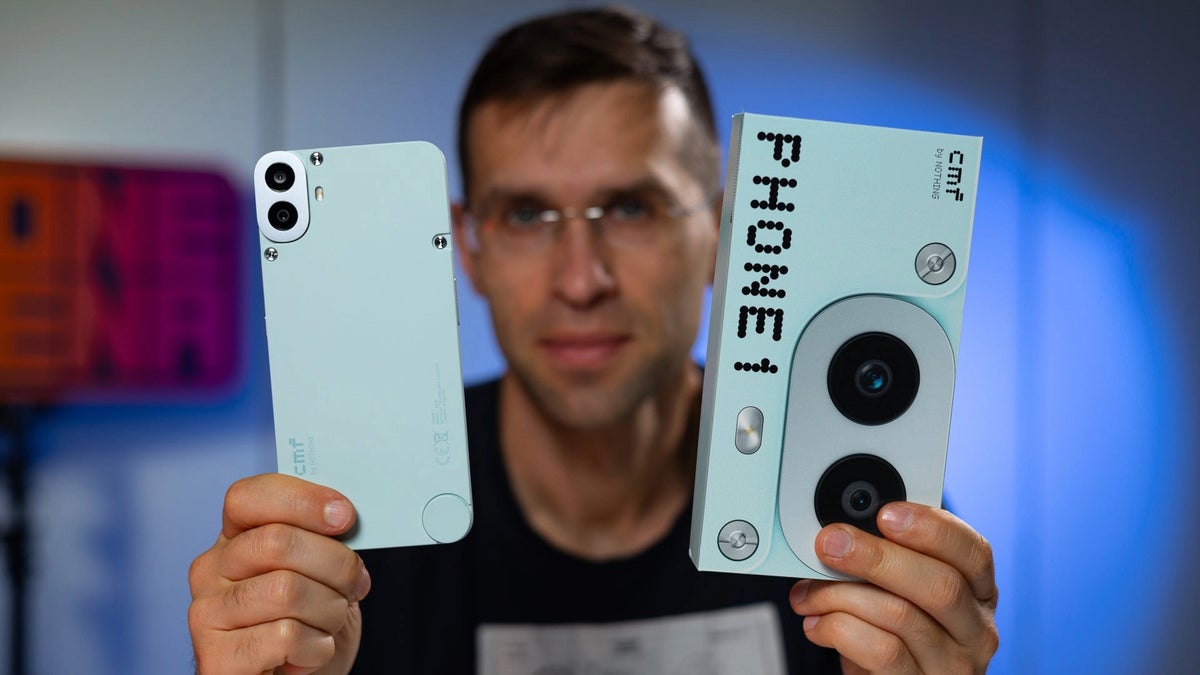 A person holding the CMF Phone (1) and its retail box in their hands.