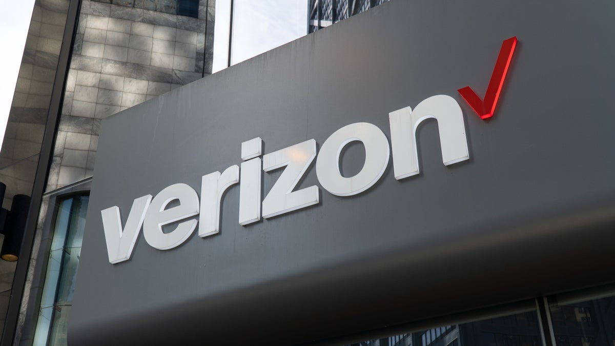 A storefront sign is the focus of this photograph which includes the carrier's logo.