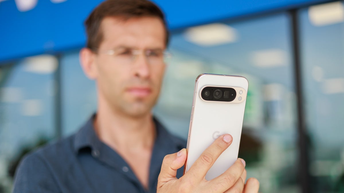 A person holding the Pixel 9 Pro XL outdoors, showcasing the phone's back design.
