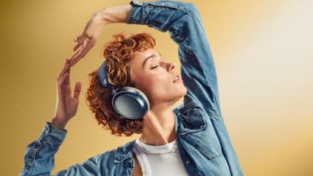A woman wearing a set of Sennheiser Momentum 4.