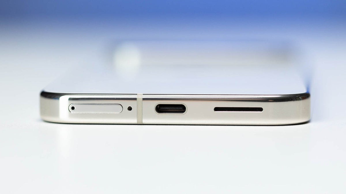 Bottom side of a phone that's laid down with screen facing the table.