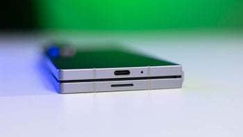 Folded Z Fold laying on a table, with charging port facing the camera.