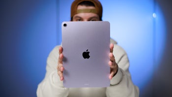 A person holds the iPad Air M3, showcasing its rear design with the iconic Apple logo.