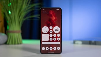 Nothing Phone (2) is shown front-on, displaying its home screen with a custom widget arrangement.