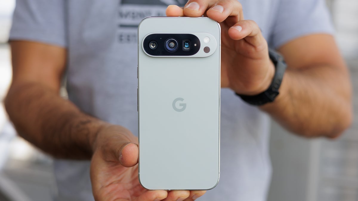 A person holding a Pixel 9 Pro with both hands.