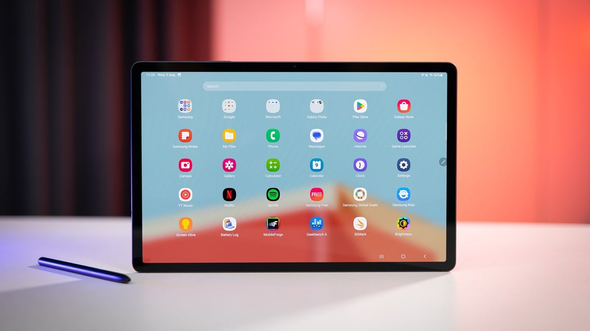 Galaxy Tab S9+ on a white table against an orange background.