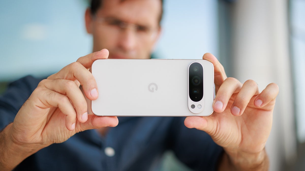 Phone Arena's Vic examines the Pixel 9 Pro XL display in landscape mode.