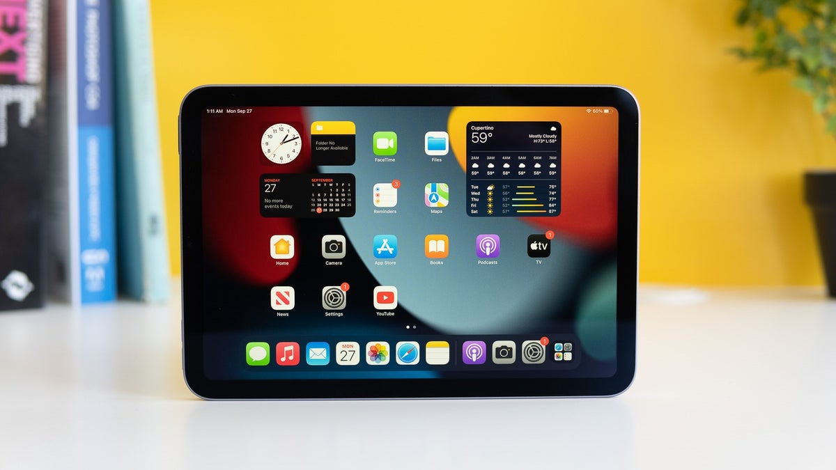 iPad mini 6 on a white table against a yellow background.